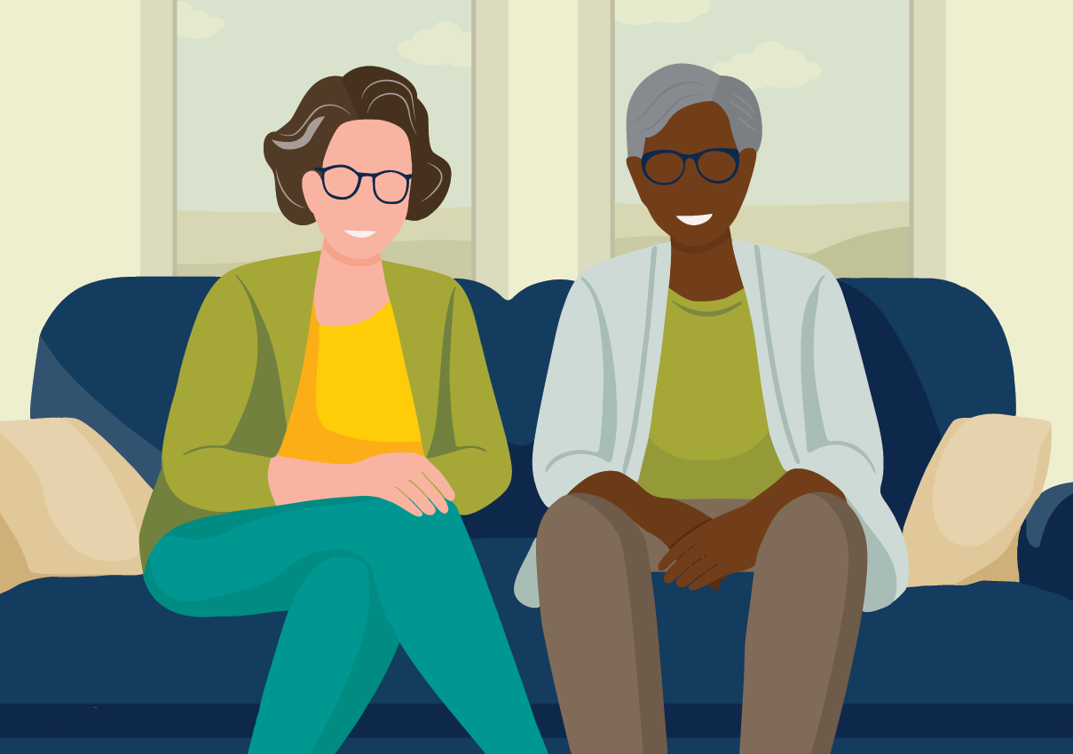 two older adults sitting on couch smiling