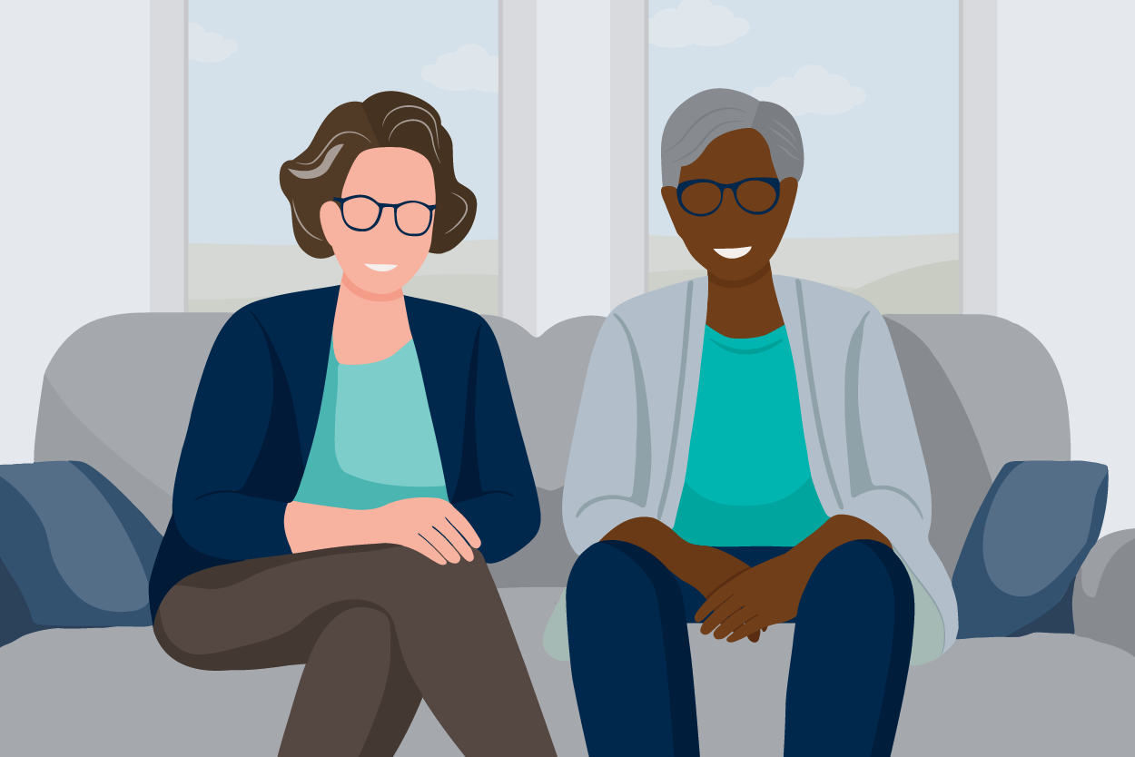 two older adults sitting on couch smiling