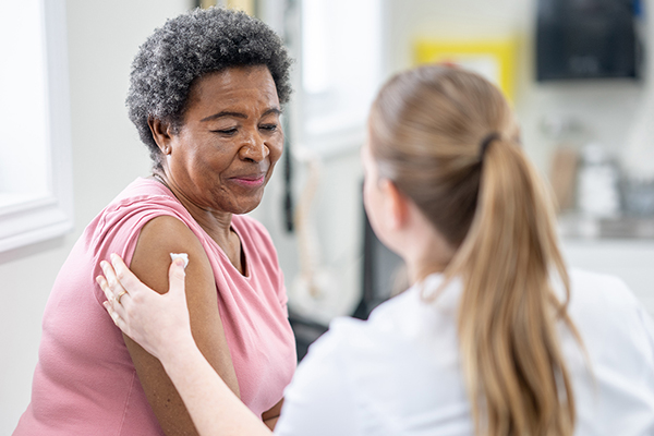 older woman receiving care after vaccine