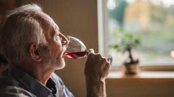 A man drinking a glass of wine