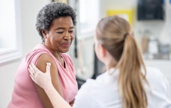 older woman receiving care after vaccine