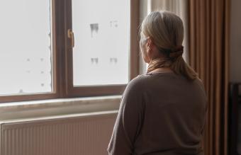 woman staring out a window