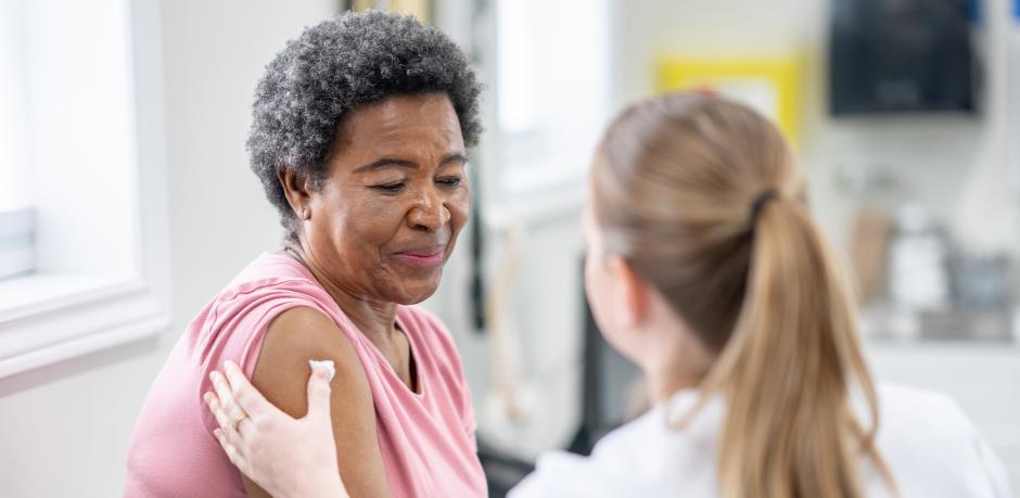 older woman receiving care after vaccine