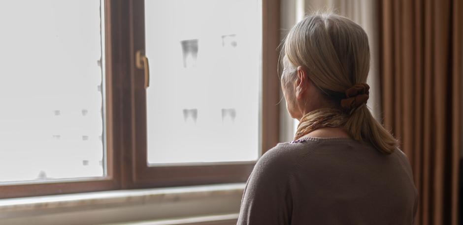 woman staring out window